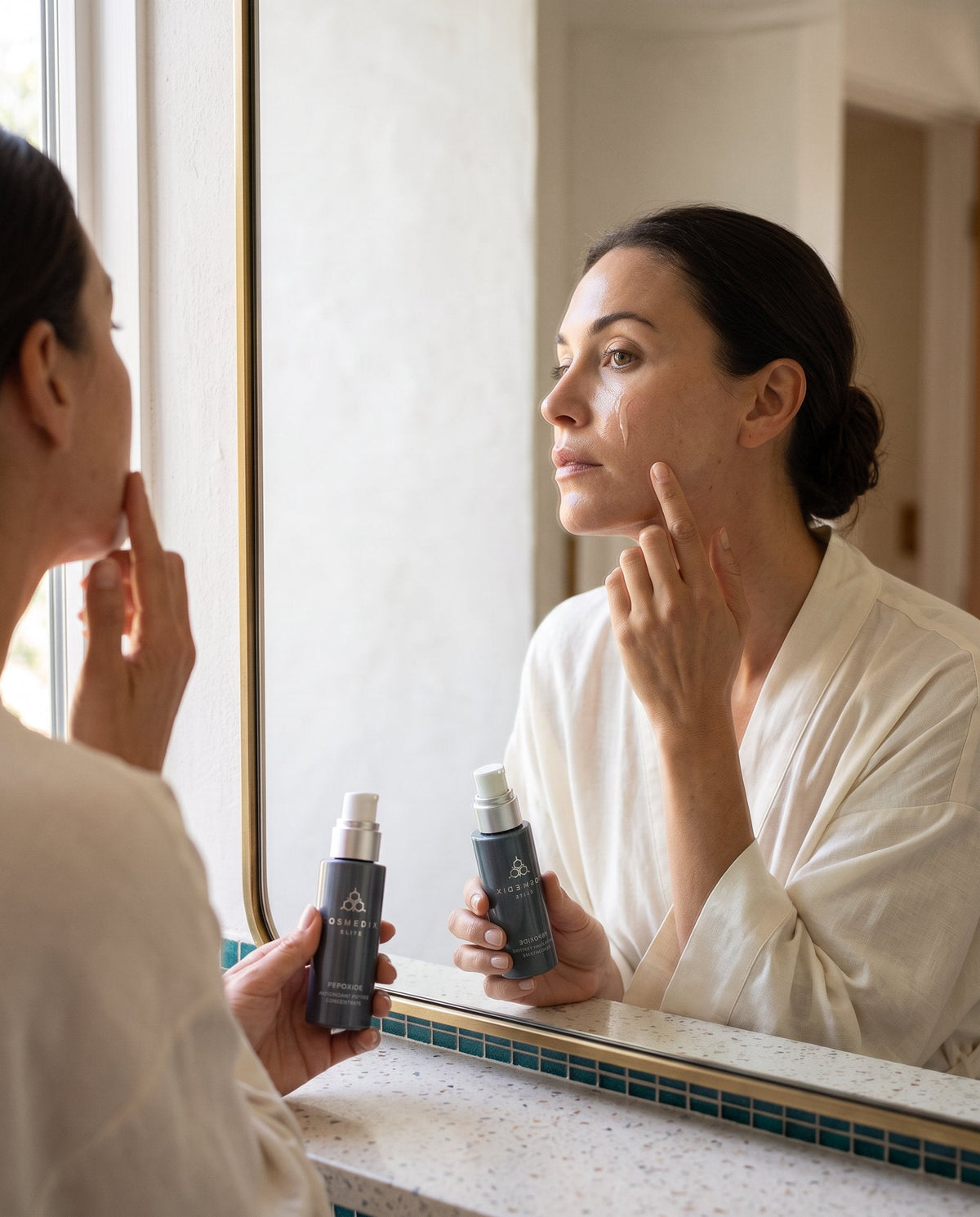 Person applying serum to clean skin as part of an evening skincare routine